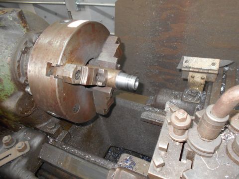 1992 Ford Bronco - Machining a metal part on a lathe, metal shavings visible.