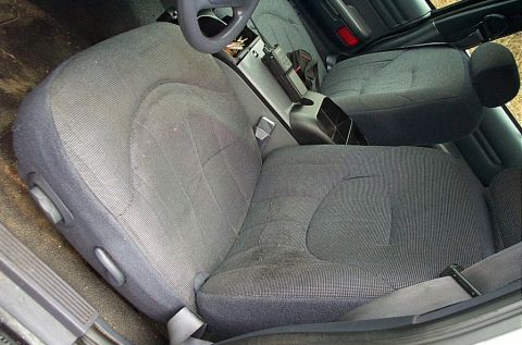 2001 Ford Crown Victoria - The interior of a car, showing the front seats and center console, possibly from a police vehicle.