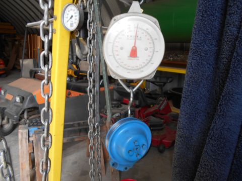 1992 Ford Bronco - A scale and chains are prominent in this garage scene, with a golf cart and lawnmower visible in the background.