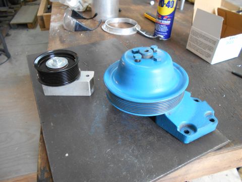 1992 Ford Bronco - Two automotive pulleys are laid out on a metal surface, possibly for repair or replacement.