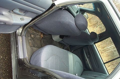 2001 Ford Crown Victoria - A view of the interior of a car, focusing on the rear seating area and door panel.