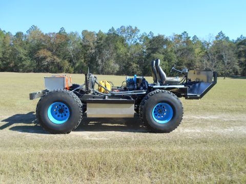1992 Ford Bronco - This custom-built off-road vehicle features large tires and an exposed mechanical setup, suggesting a focus on utility over aesthetics.