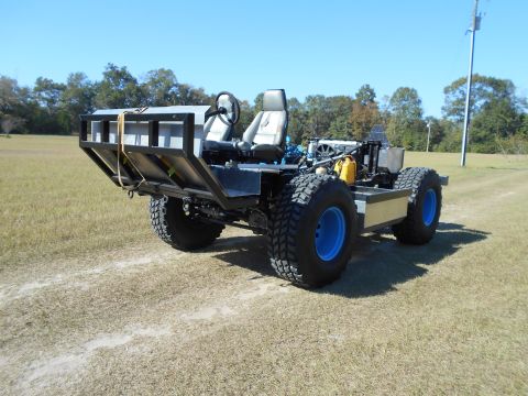 1992 Ford Bronco - This custom-built vehicle features a unique design with a flatbed and exposed engine components.