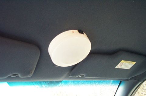 2001 Ford Crown Victoria - Overhead interior light and sun visor with a warning sticker are visible.