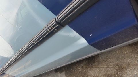 1991 Ford LTD Crown Victoria - Close-up of a car's side panel showing a black rubber trim piece.