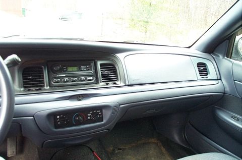 2001 Ford Crown Victoria - The interior of a 2001 Ford Crown Victoria, the dashboard with radio and climate controls.