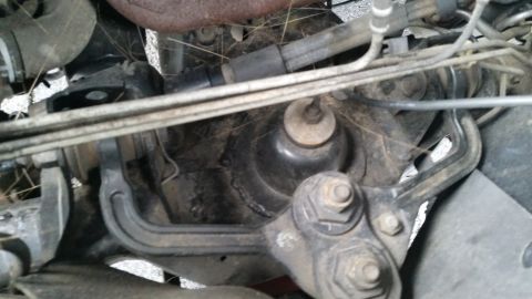 1991 Ford LTD Crown Victoria - Close-up view of a vehicle's engine mount and surrounding components.