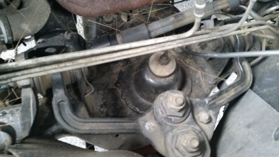Engine mount assembly with bolts and hoses