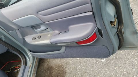 1991 Ford LTD Crown Victoria - Interior door panel of a 1991 Ford Crown Victoria LTD, showing power window controls and a door handle.