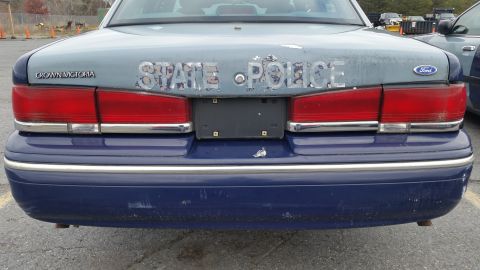 1991 Ford LTD Crown Victoria - Rear view of a 1991 Ford Crown Victoria LTD police car showing 'STATE POLICE' markings.