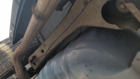 1991 Ford LTD Crown Victoria - The undercarriage of a vehicle, the fuel tank and exhaust system, is visible.