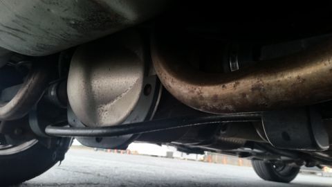 1991 Ford LTD Crown Victoria - The underside of a vehicle is visible, focusing on the differential and exhaust system components.