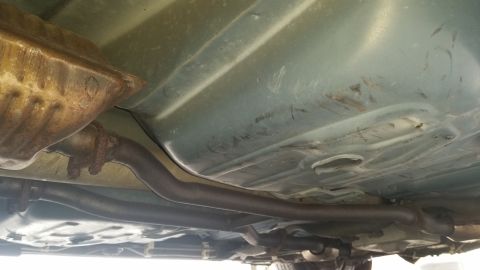 1991 Ford LTD Crown Victoria - Underside view of a 1991 Ford Crown Victoria LTD, highlighting the exhaust and fuel tank components.
