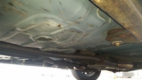 1991 Ford LTD Crown Victoria - Underside view of a car's chassis, including the exhaust system and suspension components.
