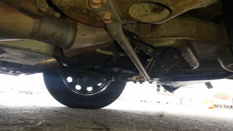 1991 Ford LTD Crown Victoria - Undercarriage view of a vehicle, including suspension and exhaust system components.
