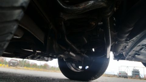 1991 Ford LTD Crown Victoria - A low-angle view of a vehicle's undercarriage, with another car in the distance.
