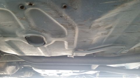 1991 Ford LTD Crown Victoria - Underside view of a vehicle, focusing on the exhaust system and undercarriage components.