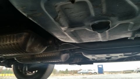 1991 Ford LTD Crown Victoria - Underside view of a car, focusing on the exhaust system and frame.