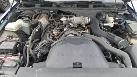 1991 Ford LTD Crown Victoria - Engine bay of a 1991 Ford Crown Victoria LTD, showing the fan shroud and various engine components.