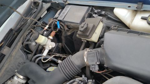1991 Ford LTD Crown Victoria - Close-up view of the engine compartment, showing various components and wiring.