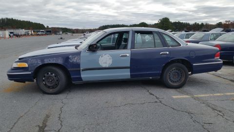 1991 Ford LTD Crown Victoria - Side view of a 1991 Ford Crown Victoria LTD police car with two-tone paint and markings.