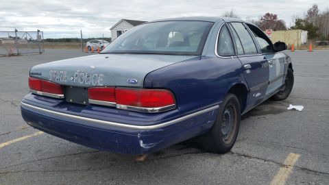 1991 Ford LTD Crown Victoria - This Ford Crown Victoria sedan, marked "STATE POLICE", is viewed from the rear, showing its two-tone paint scheme.