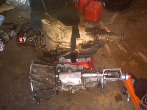 1991 Ford Crown Victoria - Two automotive transmissions are shown in a garage setting, possibly for repair or replacement.