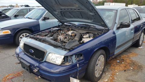 1991 Ford LTD Crown Victoria - Two-tone blue Ford Crown Victoria with hood open, parked in a lot with other vehicles.