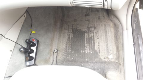 1998 Lincoln Mark VIII - Water stains are visible on the interior floor and side panel of the vehicle.