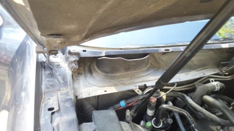 1998 Lincoln Mark VIII - View of the cowl area and engine bay, showing various hoses and mechanical parts.