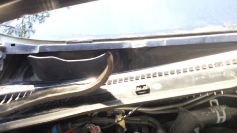 1998 Lincoln Mark VIII - The photo shows the area under the windshield wipers, revealing detached trim and wiring.