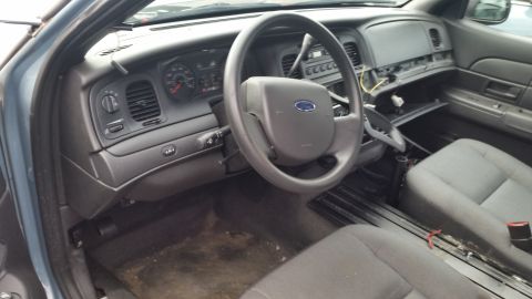 1991 Ford LTD Crown Victoria - Interior view of a car, showing the dashboard, steering wheel, and seats. The center console appears to be missing parts.