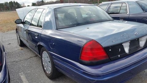 1991 Ford LTD Crown Victoria - This 1991 Ford Crown Victoria LTD is seen from a 3q-front angle with its hood open, parked next to another similar vehicle.