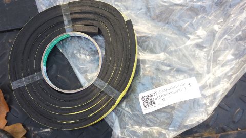 1998 Lincoln Mark VIII - Roll of weatherstripping tape, likely for automotive use, with part number visible on label.