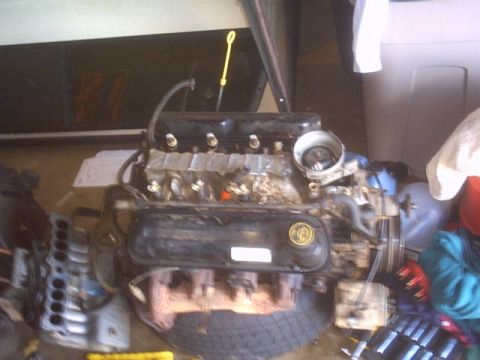 1991 Ford LTD Crown Victoria - Engine assembly with black valve covers and exhaust manifolds, possibly a Ford V8.