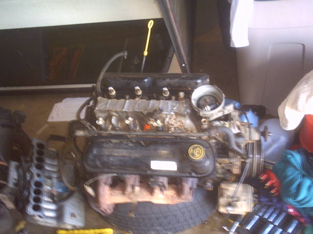 Ford V8 engine with black valve covers and exhaust manifolds