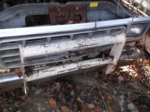 1974 Dodge Challenger - Front view of a weathered 1973 Ford F-Series pickup truck, showing its grille and bumper.