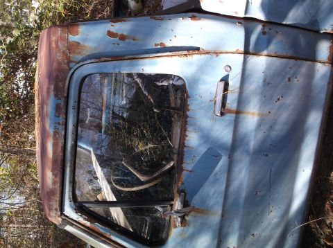 1974 Dodge Challenger - This heavily rusted truck door, likely from an older model, shows significant wear and tear.
