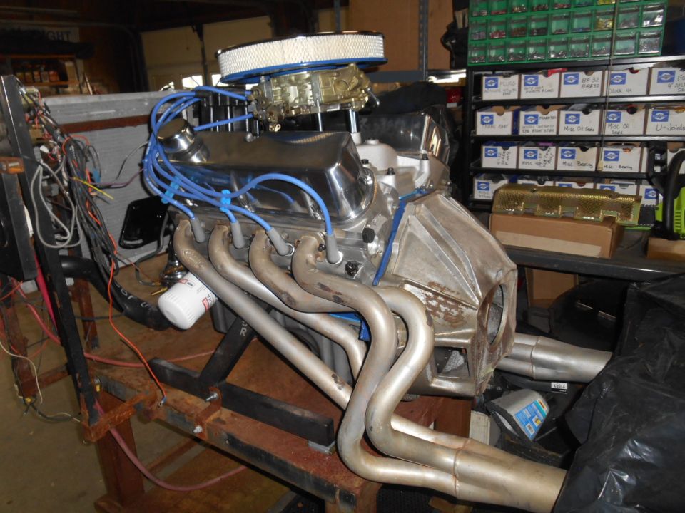 Engine with chrome valve covers and headers on a stand