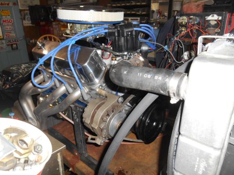 1972 Ford Bronco - Engine assembly on a stand with chrome valve covers and headers visible.