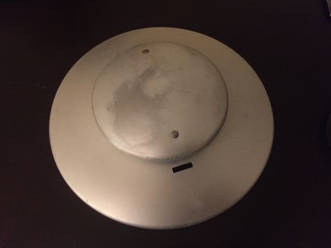 2014 Dodge 1500 - A close-up of a silver wheel cover is shown against a dark background.