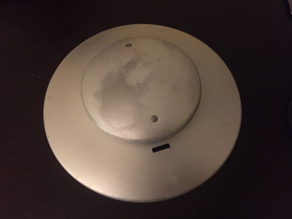 wheel cover with two small holes and a rectangular slot