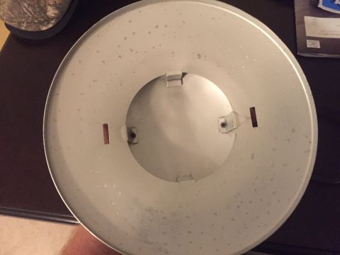 2014 Dodge 1500 - A close-up view of a circular dust cover with visible mounting clips and some surface dirt.