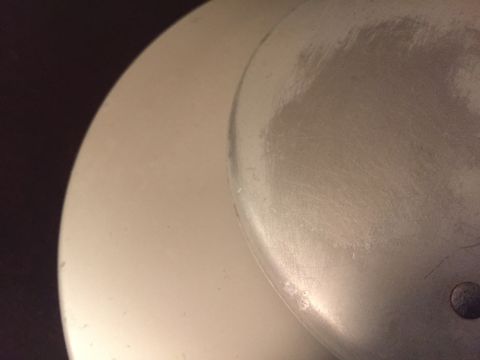 2014 Dodge 1500 - A close-up view of a silver wheel cover, showing signs of wear and scuff marks. The 'Supermotors' logo is visible in the lower right corner.