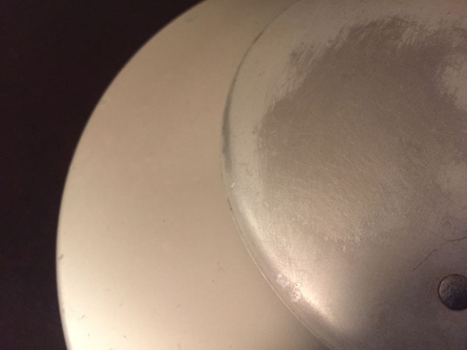 Close-up of a silver wheel cover with scuff marks