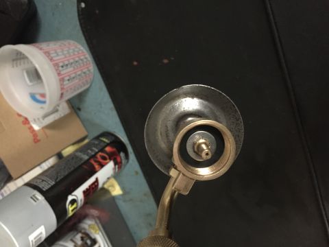 2014 Dodge 1500 - A close-up view of a propane torch nozzle, showing its brass fitting and metal cap.