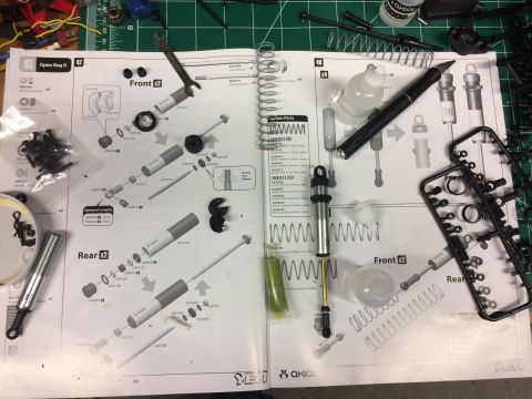 1989 Ford Bronco - Instruction manual and parts for assembling RC car shock absorbers, including front and rear components.