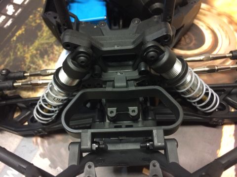1989 Ford Bronco - The suspension system of a remote control car features adjustable coilover shocks and linkage rods.
