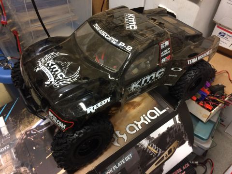 1989 Ford Bronco - RC car body with KMC Wheels and Team Associated decals sits on a box.