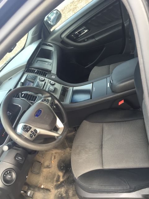 2013 Ford Taurus - Interior view of a 2013 Ford Taurus, highlighting the dashboard and seating.